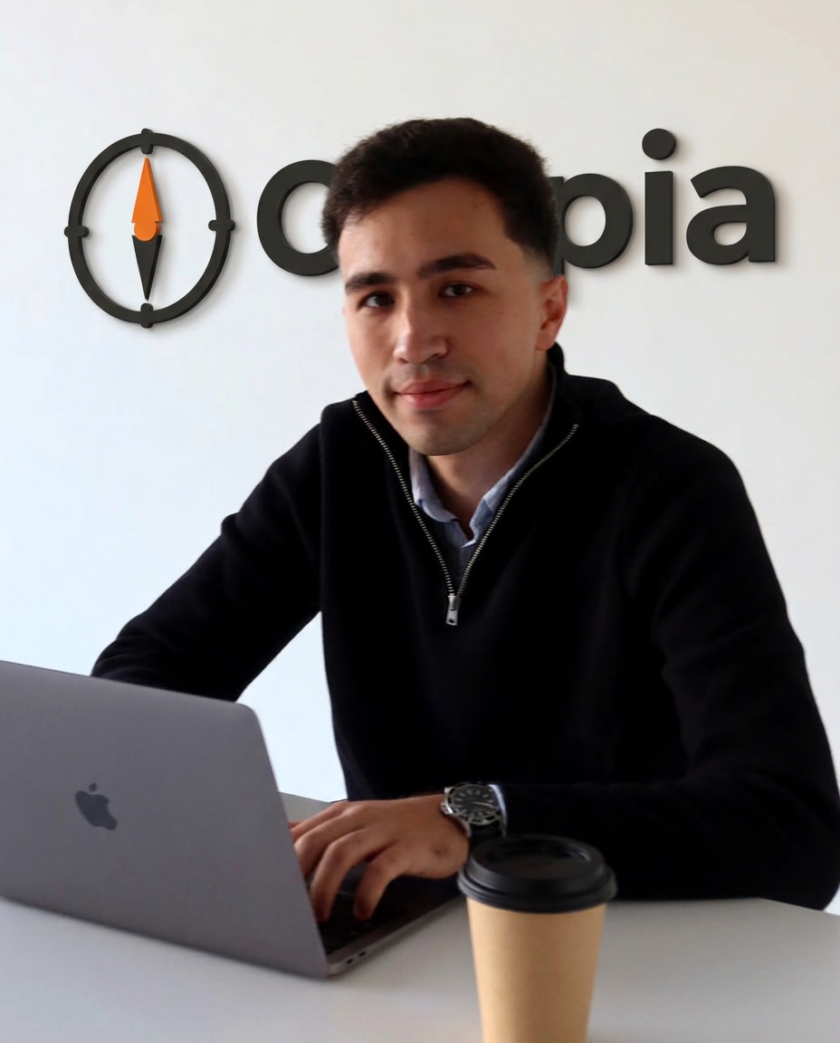 Bahti Sultanov, founder of Caspia, seated at a desk with a laptop